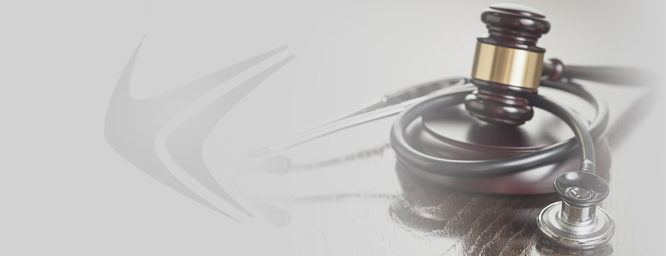 Gavel and Stethoscope on Reflective Wooden Table